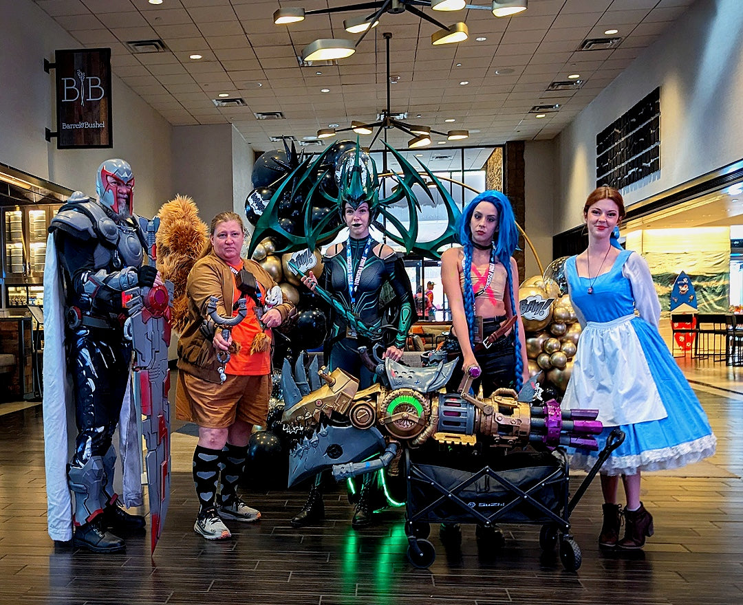 Cosplay group displaying elaborate armor and handheld props
