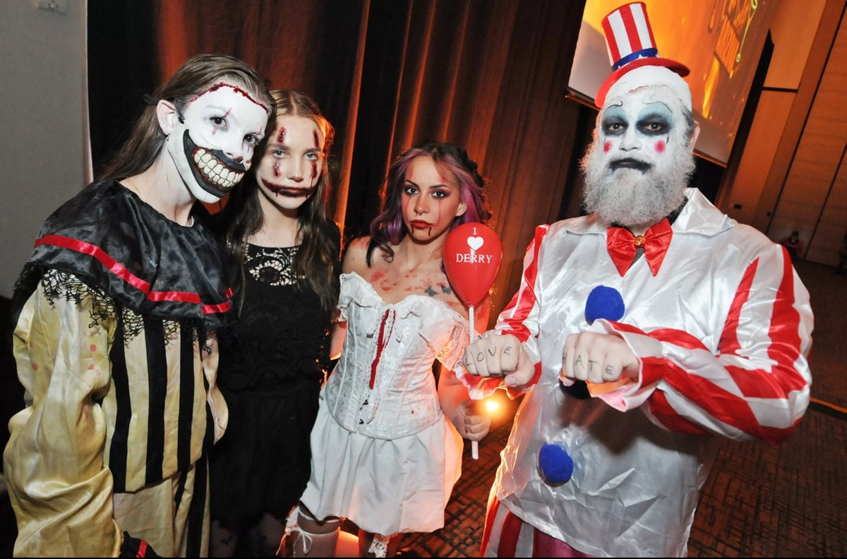 Four people wearing horror costumes and theatrical makeup at an event